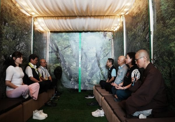 在靈鷲山佛教教團監院廣純法師(右一)引導下,貴賓在「心和平號」禪修巴士內體驗。(圖由靈鷲山佛教教團提供)